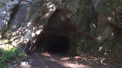 Dark cave in the forest,sun