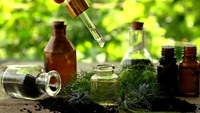 Black cumin oil in a bottle. Selective focus.
