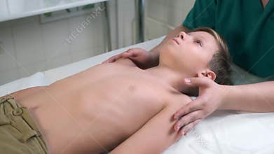 A session of craniosacral therapy, cure of teen boy spine by a doctor therapist.