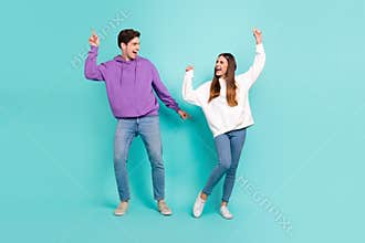 Full size photo of funky careless people dancing having fun enjoying music free time isolated on blue color background