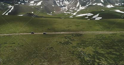 Aerial view of 4x4 cars travel off road in mountains