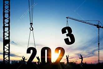 Silhouette of construction worker with crane and cloudy sky for preparation of welcome 2023 new year party and change new business