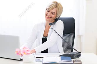 Senior business woman speaking phone