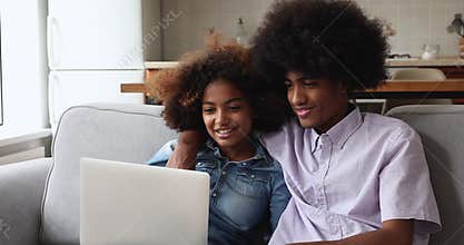Young married African couple do internet shopping using laptop