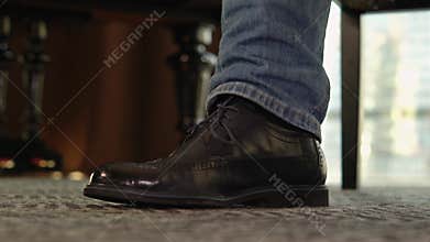 the foot beats a rhythm on the floor.