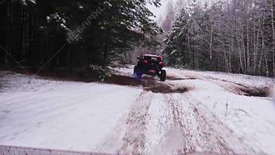 Extreme ride through the winter forest by mud and puddles on UTV vehiles.