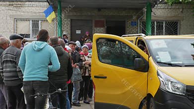 Kharkiv Kharkov region, Rogan, Ukraine - 05.10.2022: crowd people waiting for medical humanitarian aid from Red Cross