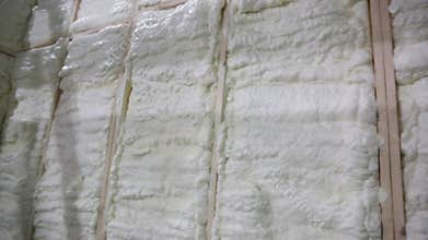 Builder apply insulating foam on the wall of a wooden house, foam insulation
