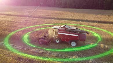 Autonomous, driverless electric grain harvester collects grain in an agricultural field in sunny sunset weather. Smart