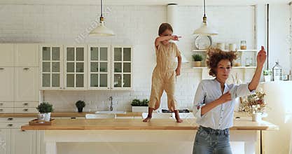 Happy young mother having fun with crazy little daughter.