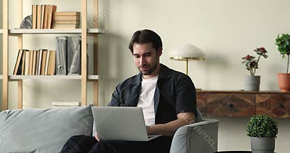 Pensive young man author create new story text using laptop