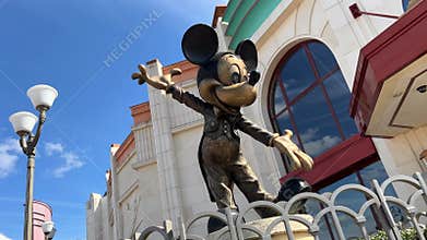 Disneyland street colorful houses a lot of people bright happy life blue sky and fabulous buildings and cartoon