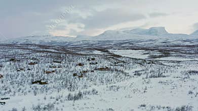 Aerial view of winter forest and mountain landscape in Sweden.