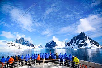 Stunning Lemaire Channel, Antarctica, tourists watching entry in channel filled with ice between mountains, Antarctic Peninsula