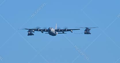 Military helicopters air refueling by turboprop cargo aircraft