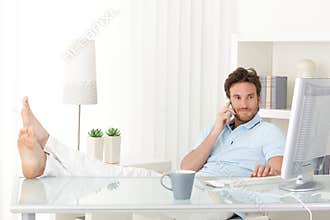 Cool man with feet up on desk
