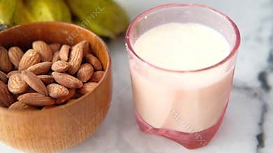 almond nut , banana and milk on table