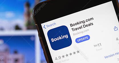Los Angeles  USA - 24 December 2020: Booking.com Travel app logo on phone screen close up with website on background with icon