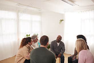 People Attending Support Group Meeting For Mental Health Or Dependency Issues In Community Space