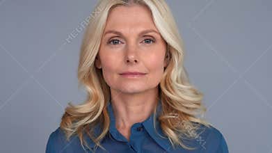 Confident 50s middle aged blond woman looking at camera.