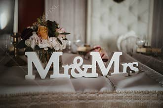 a white wood Mr Mrs letter on the chair