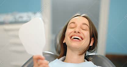 Portrait of a woman happy with her smile at the dental office