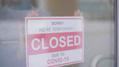 Closed for business due to covid. Small shop puts closed sign up on storefront