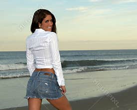 Woman in White Shirt and Jean Skirt Looking Over Back