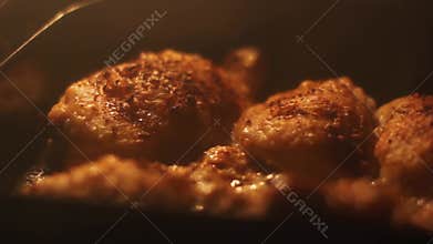 Chicken thighs are baked in the oven. Fried chicken