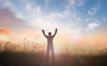 Silhouette Man Raising Broken Chains at Sunrise Symbolizing Freedom and New Beginning