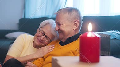 Happy retired couple enjoying valentines day with candle lights. Love romance and dating at old age