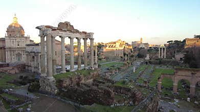 Wonderful panning at sunset in ancient Roman Forum with ruin of famous Temple and building