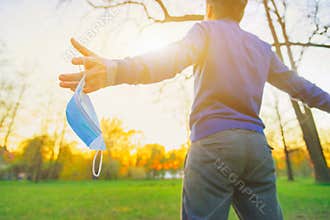 Happy fun man open hand arms take off face mask, put back. Covid 19 sick stop, lockdown end after ill. New normal safe life escape