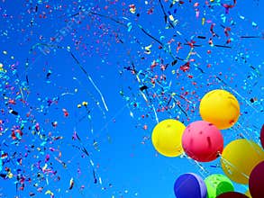 Multicolored balloons and confetti