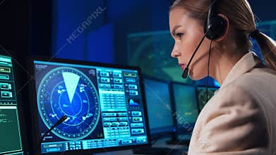 Workplace of the professional air traffic controller in the control tower. Female aircraft control officer works using