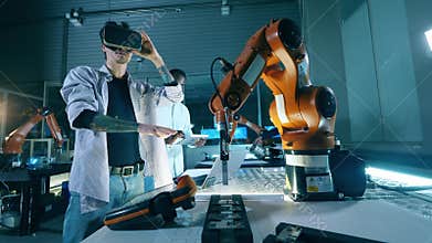 Engineer controlling robot using virtual reality glasses. Innovation, technology concept.