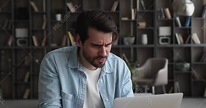 Man working on laptop feels angry due no internet access