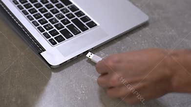 Hand connecting usb hard drive to laptop, modern personal computer technology