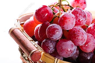 Bunch of red grapes in a basket.