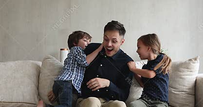 Young loving dad play with lovely kids