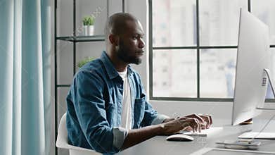 African freelancer works on project on contemporary computer