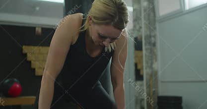 Fitness healthy woman tired after strength training exercise at gym. Rest after training. professional athlete in the