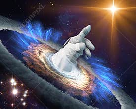 Astronaut hand in gloves points with finger to a shining star in space through a black hole portal.