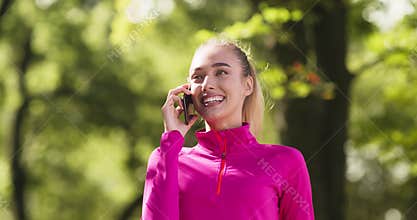 Close up portrait of happy young blonde lady talking on cellphone, enjoying pleasant talk with friends or family