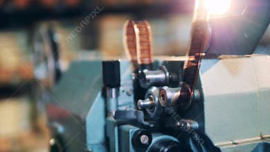 Tape is getting put into the antique cinema projector