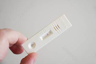 hand showing negative result on corona covid-19 antigen test cassette