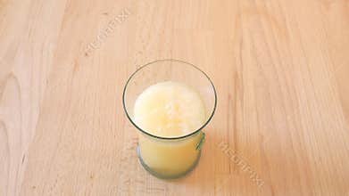 Preparing fizz drink from crystal water and vitamins effervescent tablet. Wooden table in the kitchen.