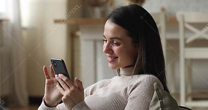 Relaxed happy young beautiful woman using cellphone.