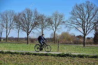 Boy rides a bike in rural landscape