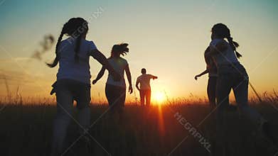 happy family. people in park children a kid together run in park at sunset silhouette. mom dad daughter and son run